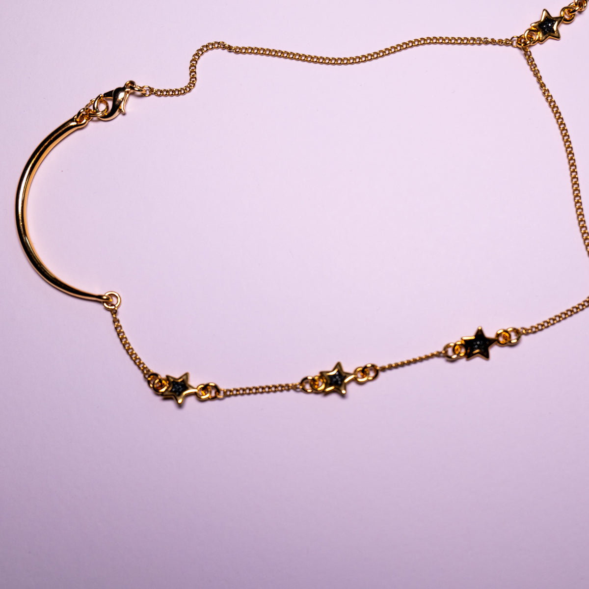 Starlit Path Hand Chain | Goudkleurige handsieraad met zwarte sterren