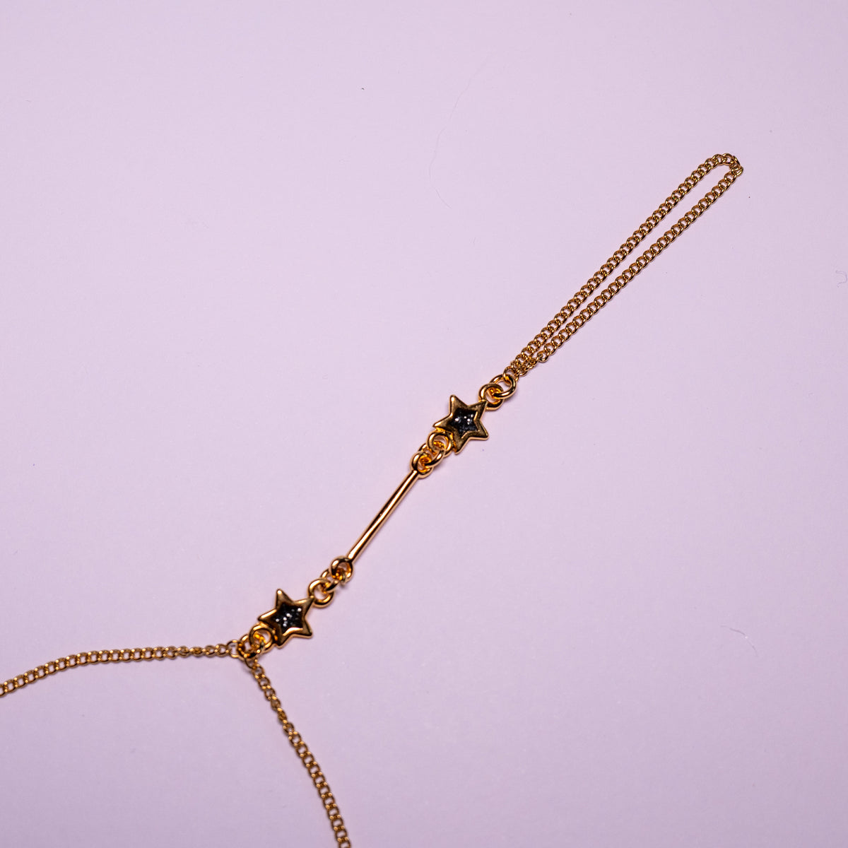 Starlit Path Hand Chain | Goudkleurige handsieraad met zwarte sterren